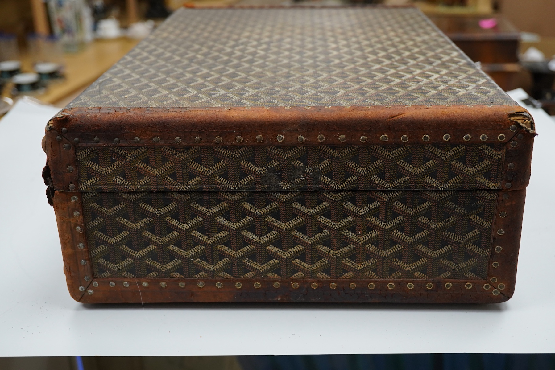 A vintage Malles Goyard suitcase with all over printed design, applied metal label to the exterior, height 13cm, width 49cm, depth 30cm